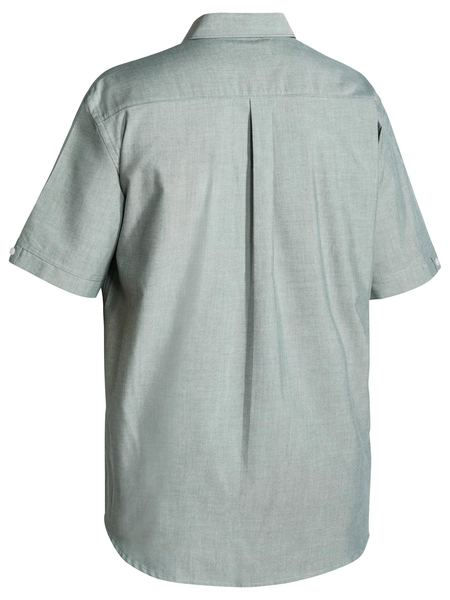 A green coloured mens work shirt with collared neck and button down closure. It has two chest button open pockets with pleat detailing. Also comes with a back pleat and mix fabric for comfort and flexibility.